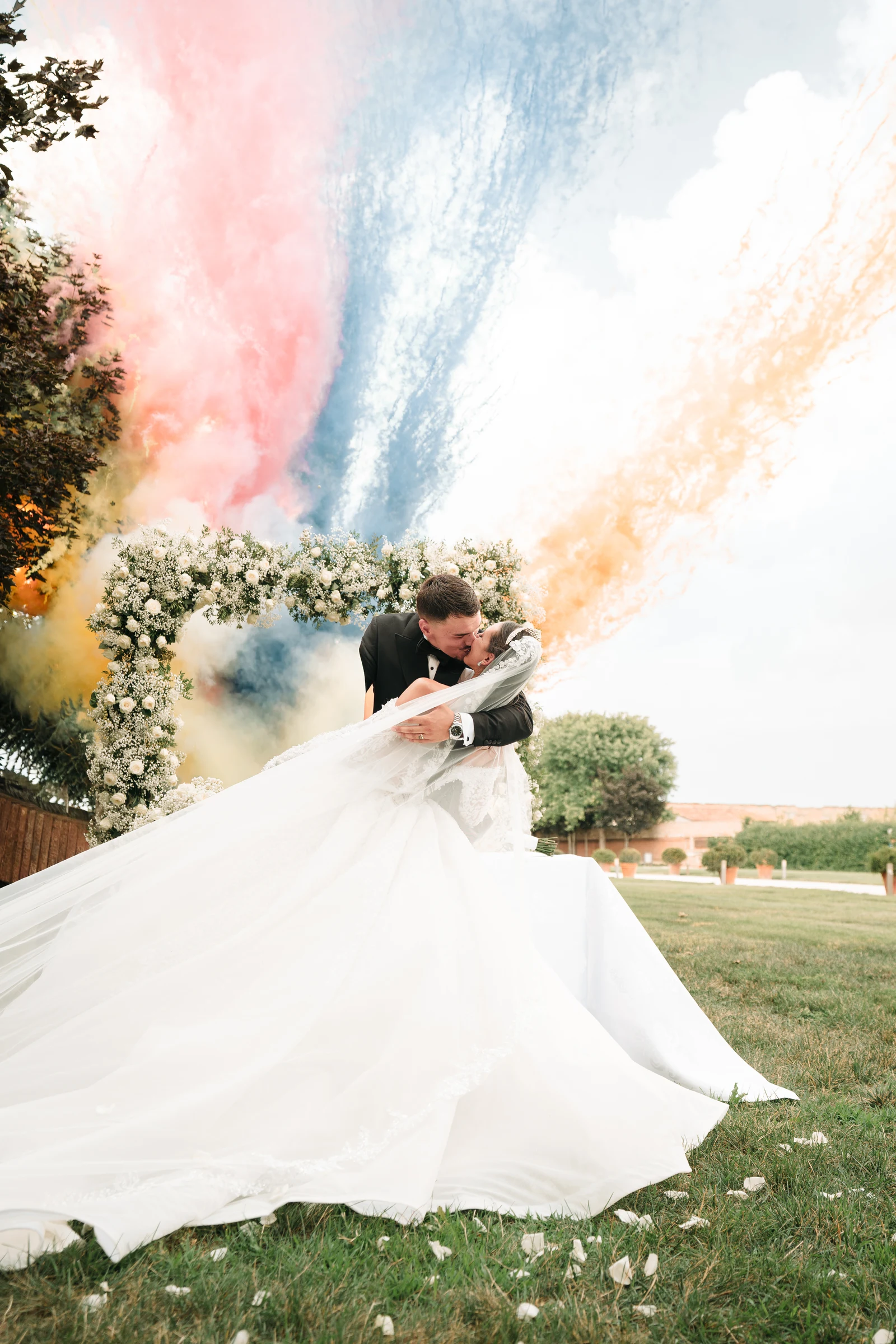 Bride moving through clouds of coloured smoke