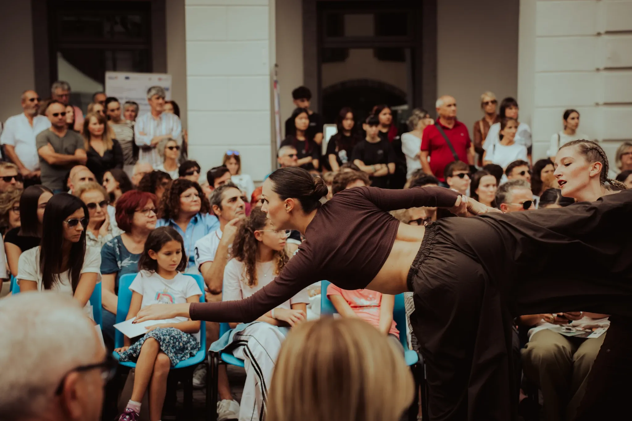 Two dancers performing before an outdoor audience