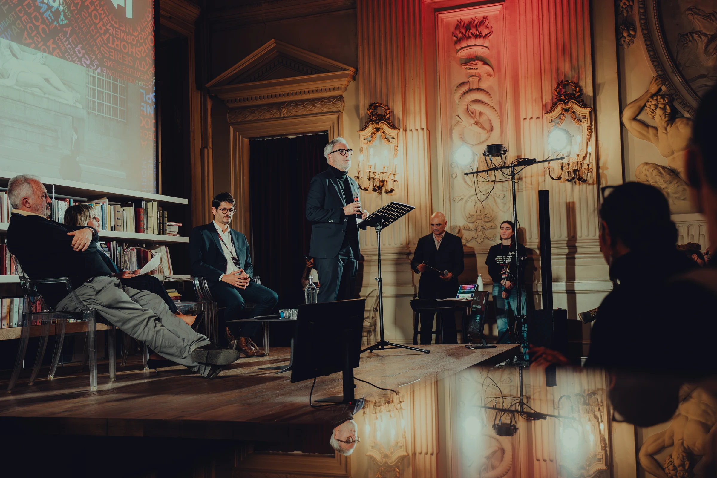 Speaker addressing an audience in a historic hall