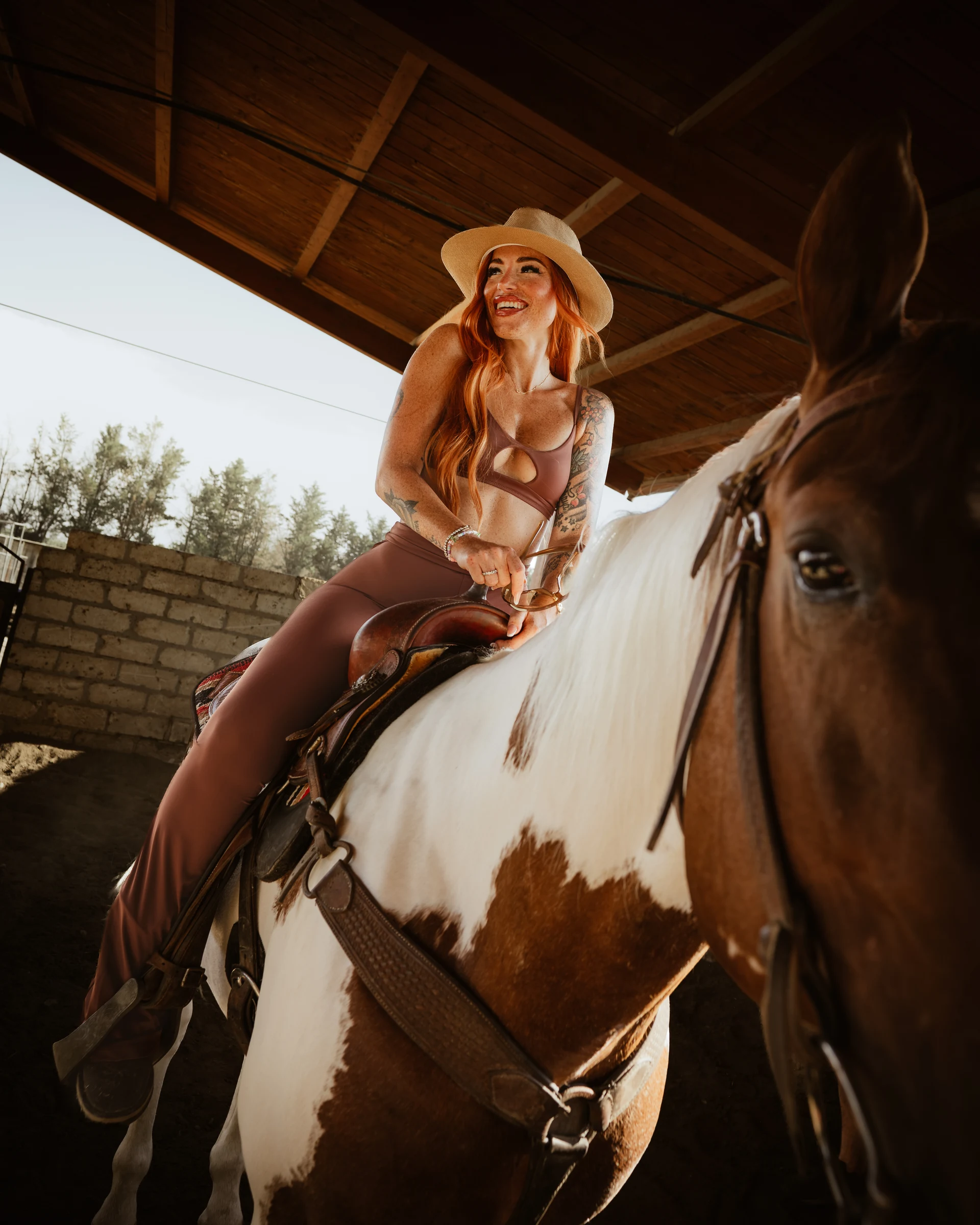 Model in western clothing photographed on horseback