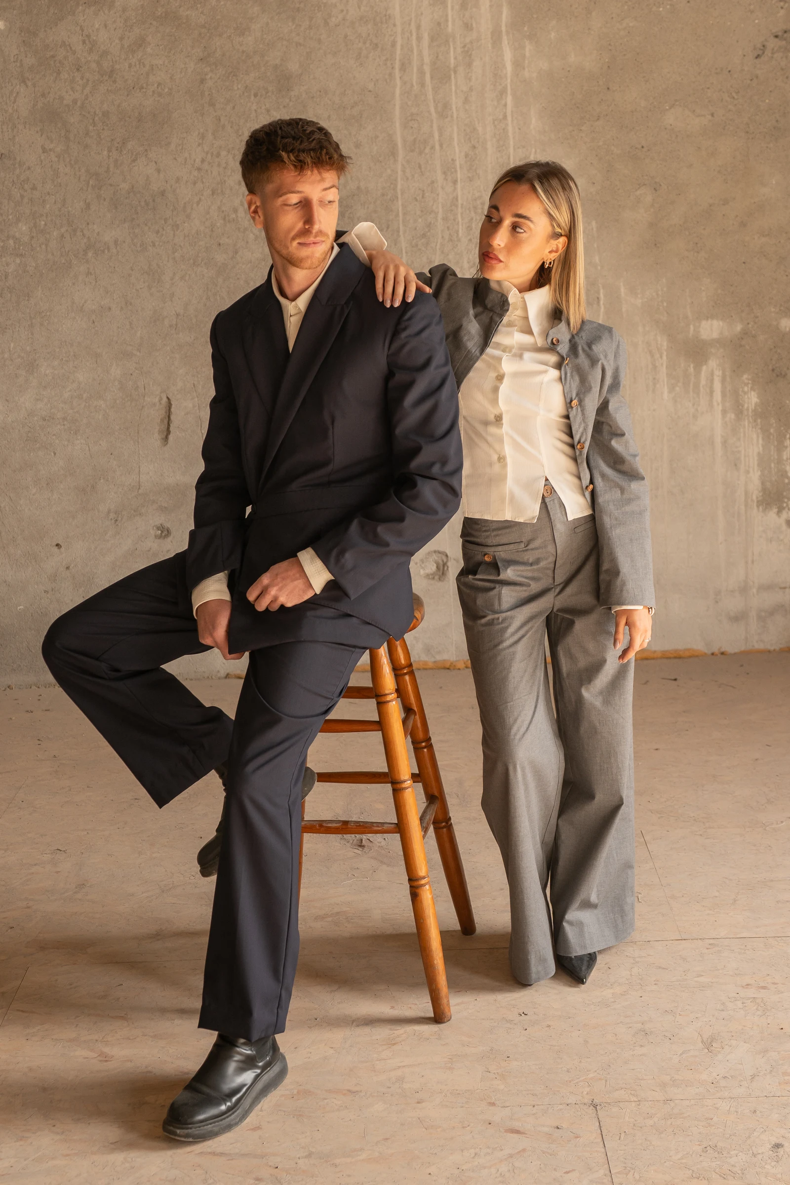 Two models in contemporary outfits inside a studio