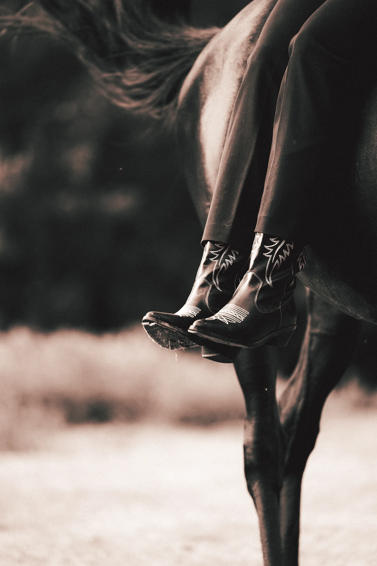 Close-up of boots worn by a rider on horseback