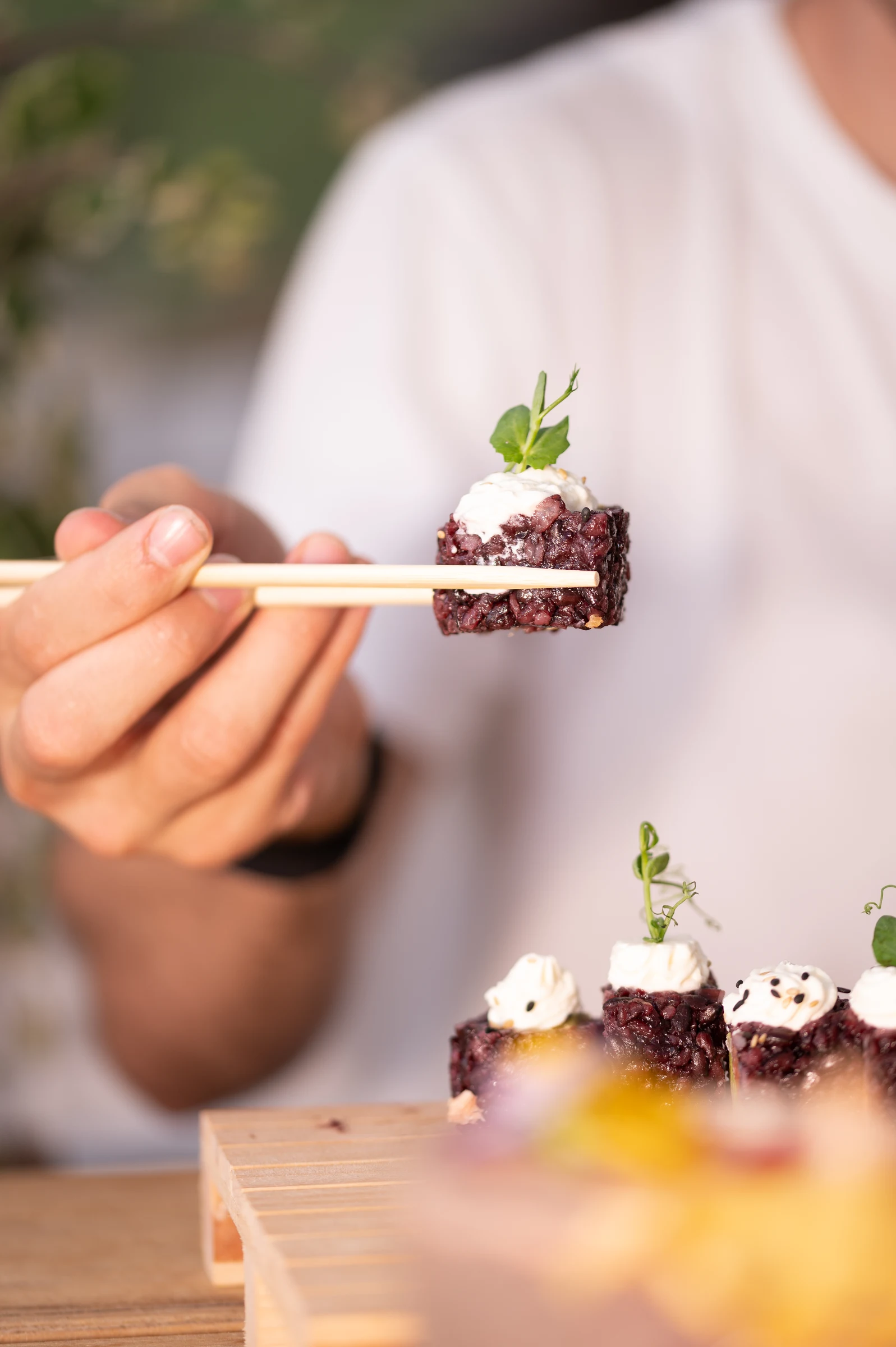 Fine dining bite being tasted with chopsticks