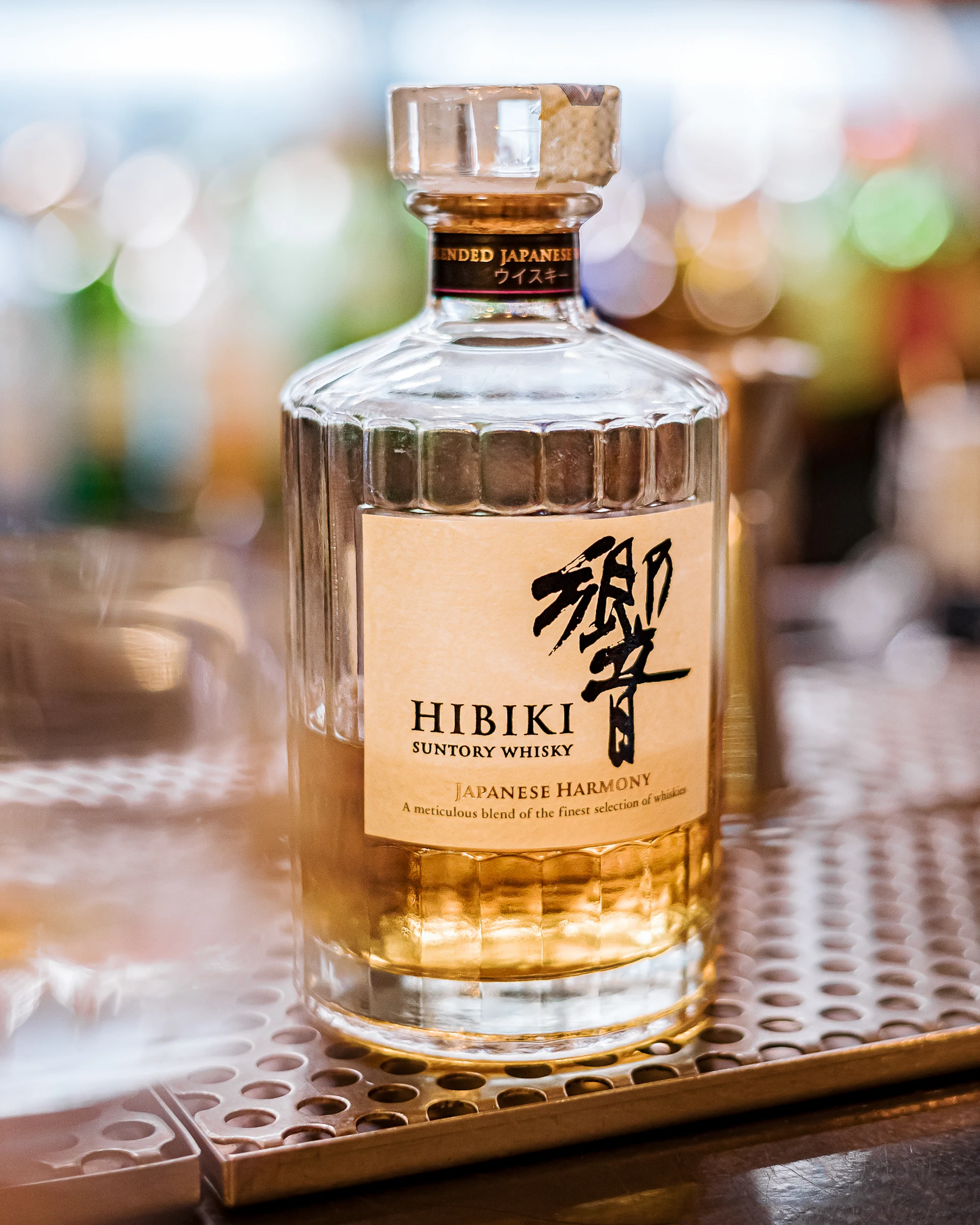 Bottle of Hibiki Japanese whisky photographed on a bar