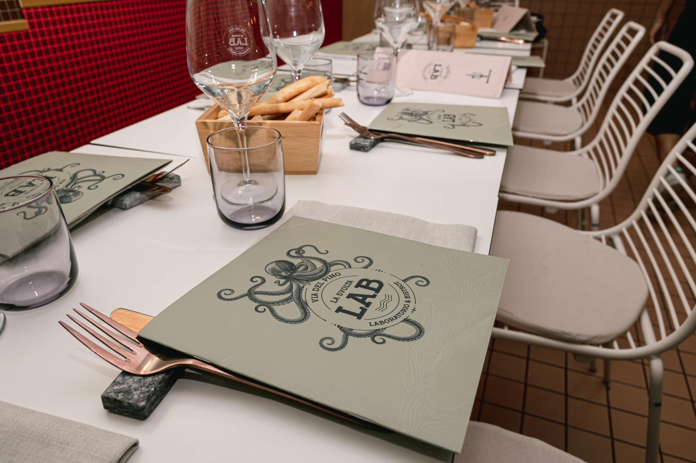 Restaurant table set with menus and glasses