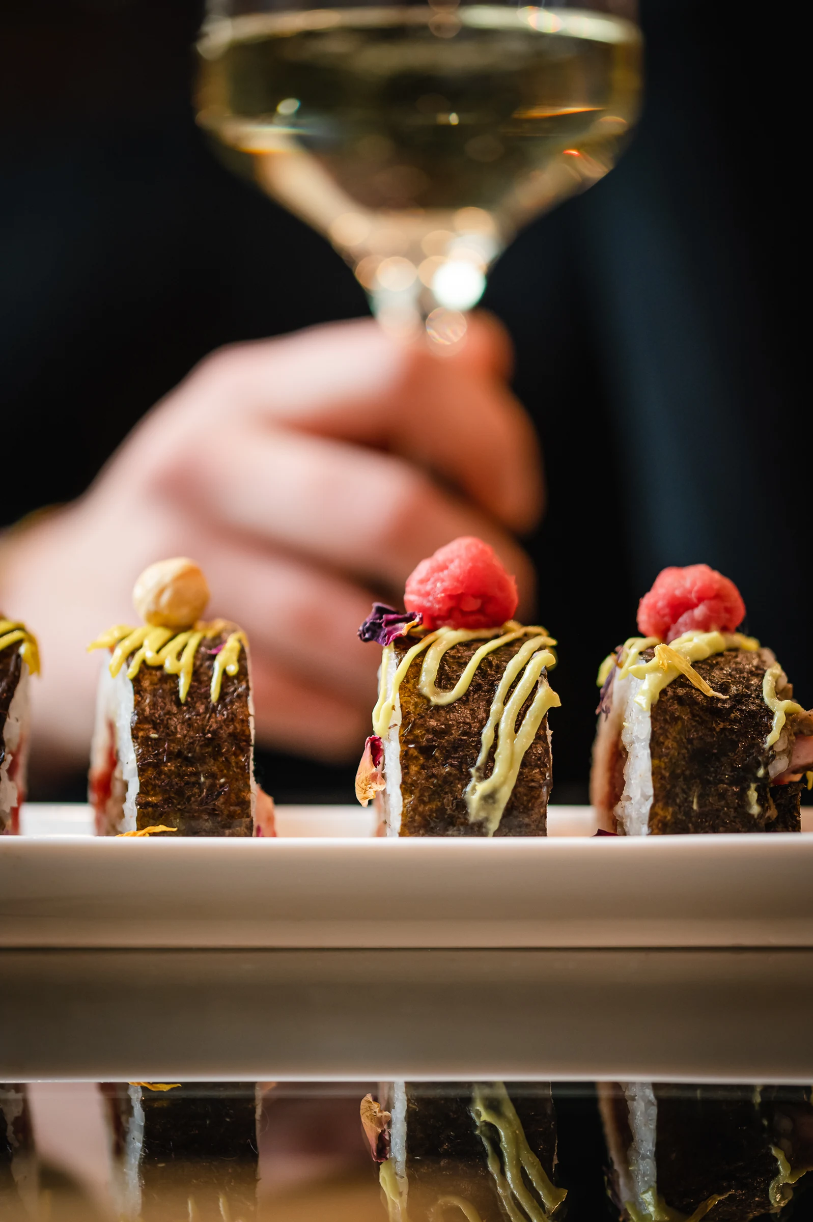 Raspberry desserts lined up on a counter