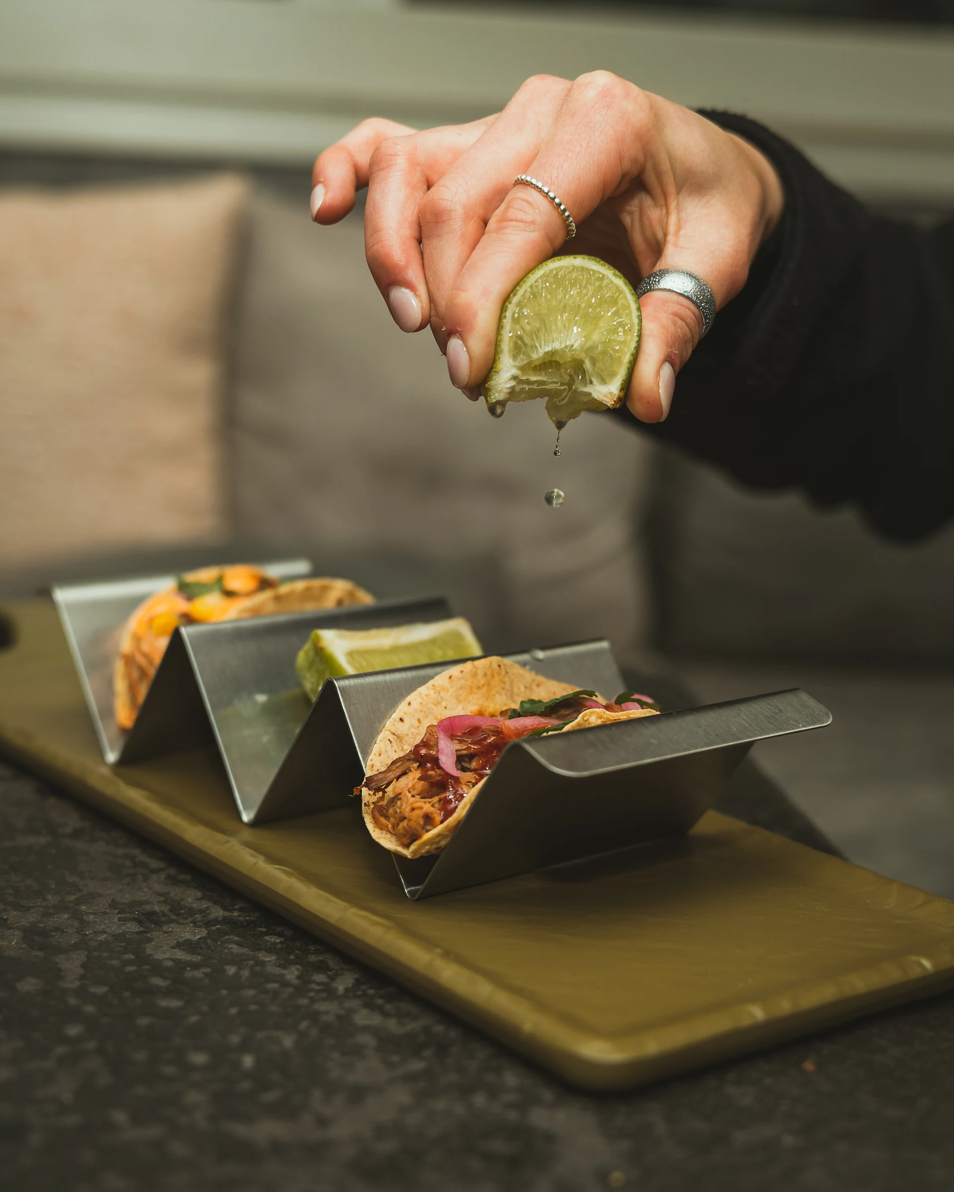 Gourmet tacos served on a contemporary stand