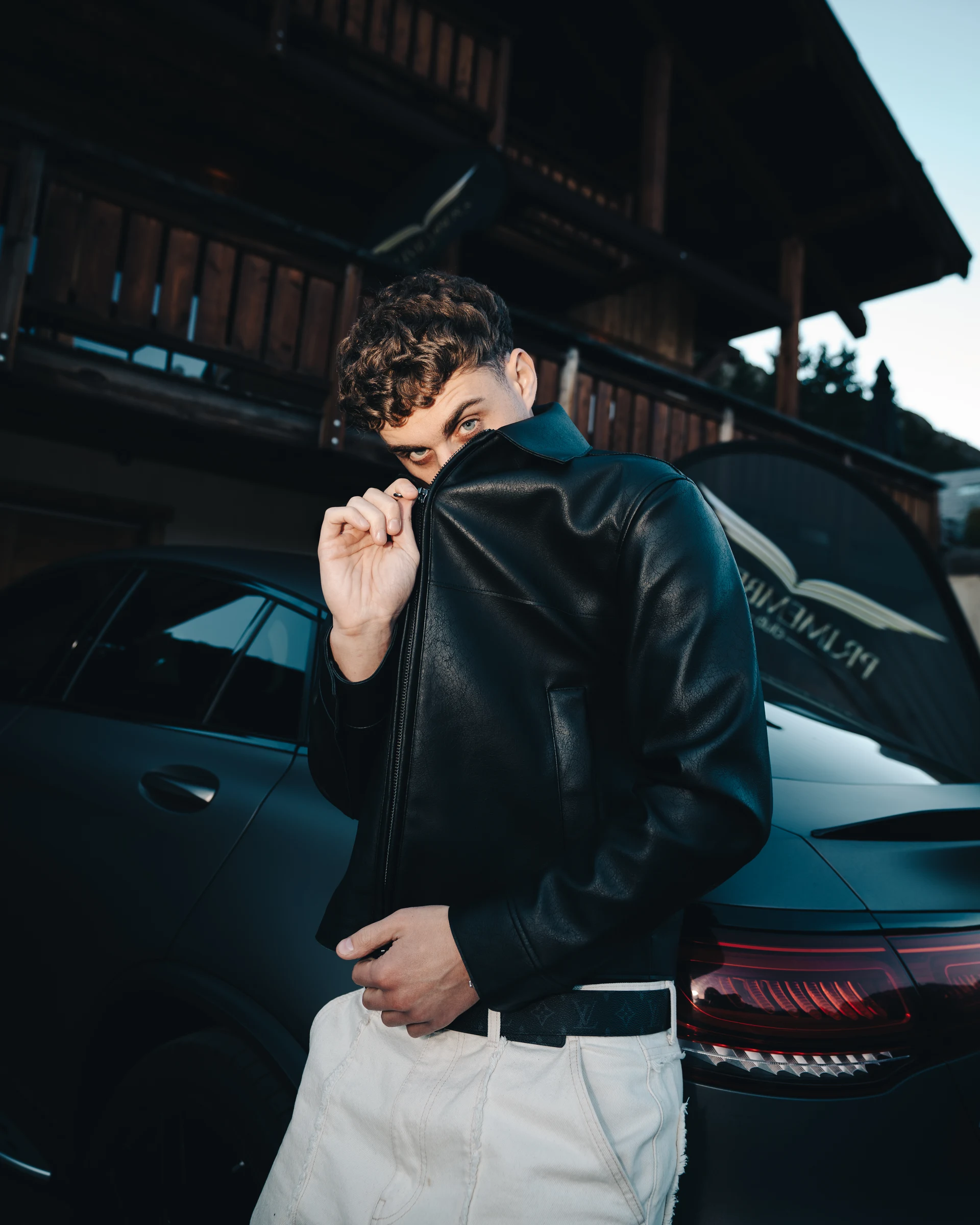 Male portrait beside a car in an Alpine setting