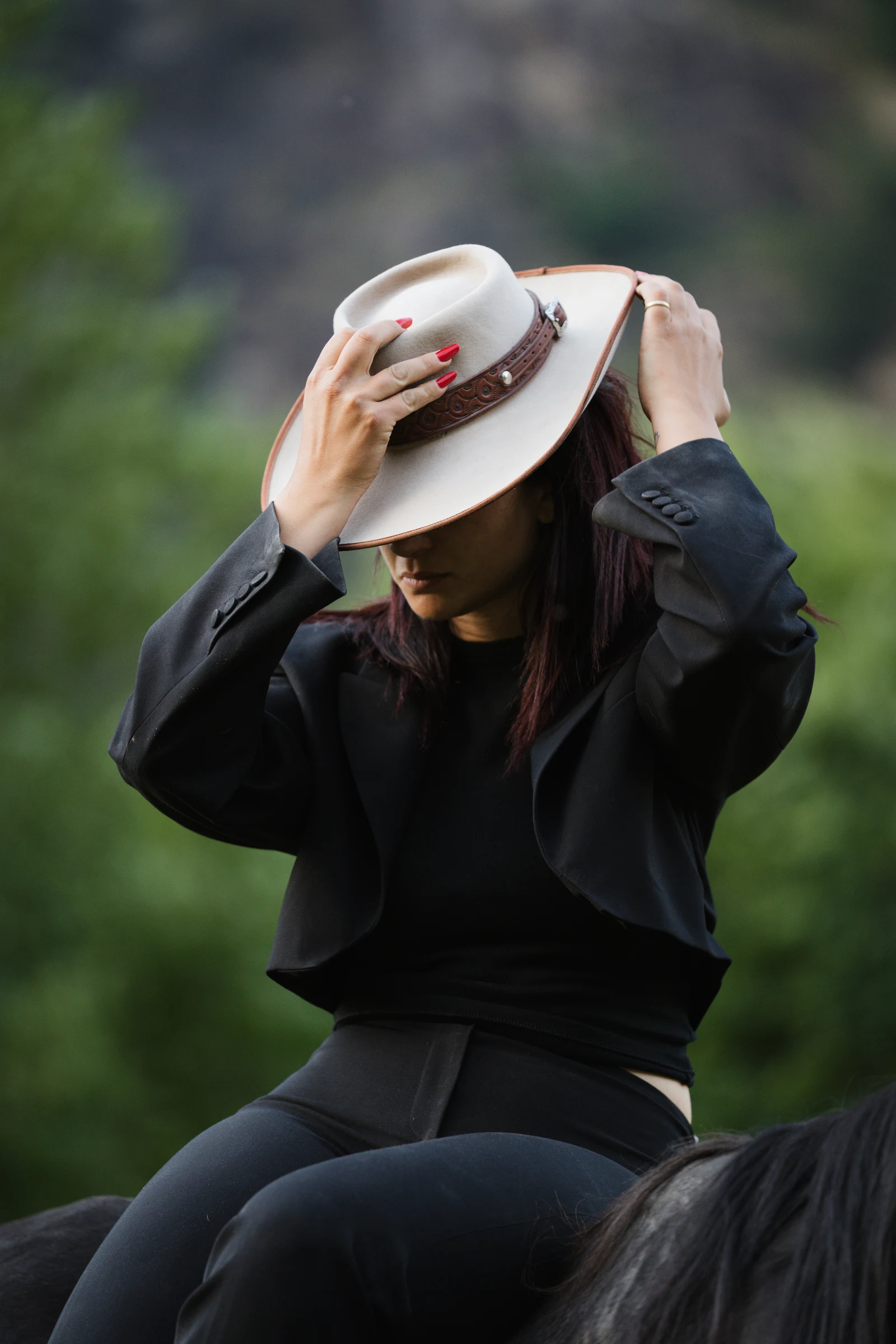 Cowgirl hat detail in a portrait of a horse rider