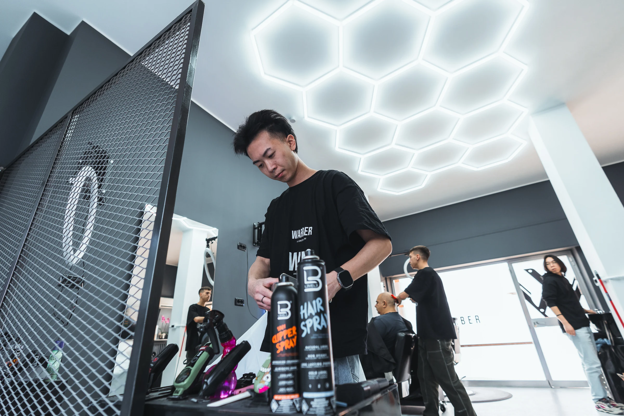 Barber presenting a professional product in a modern salon