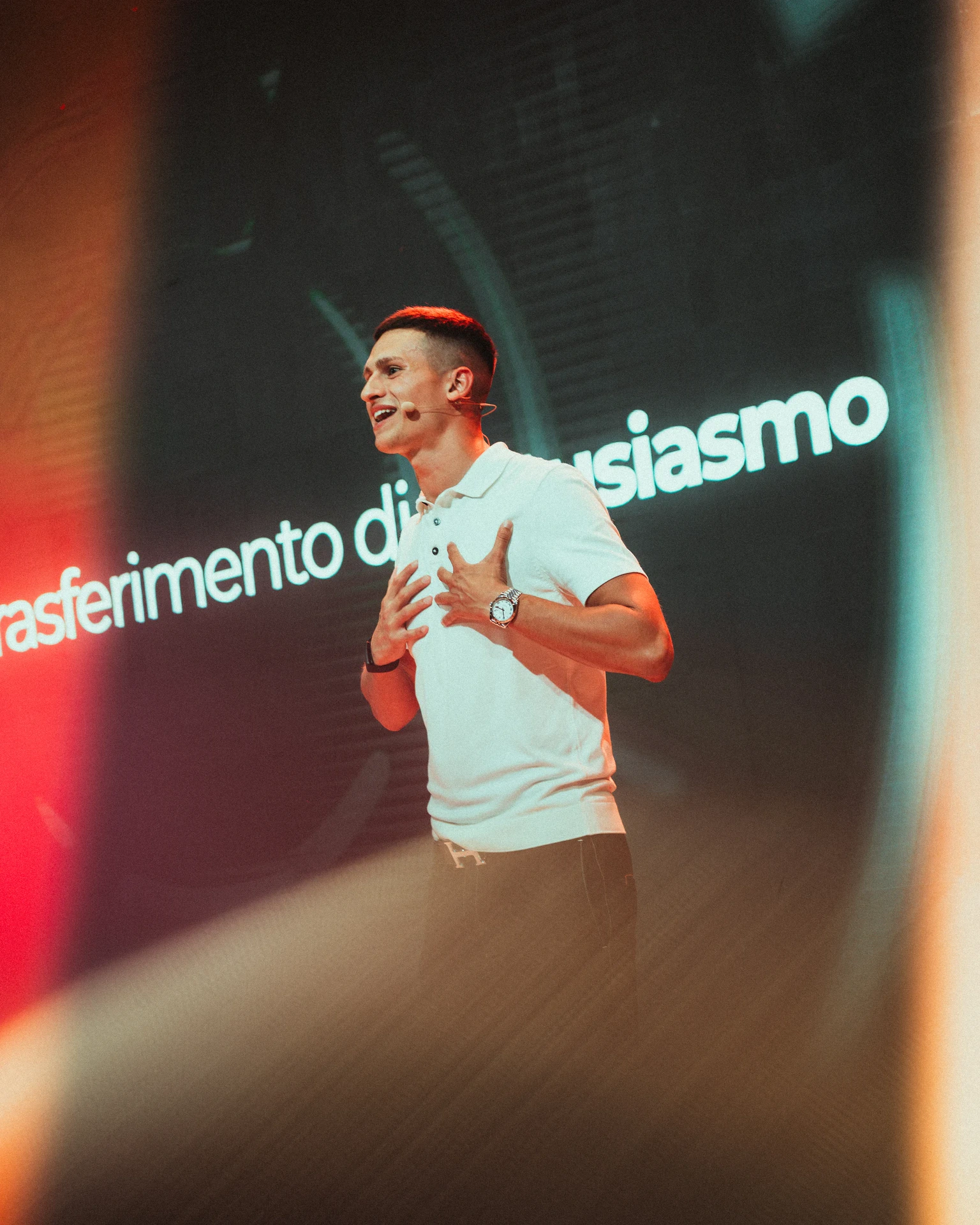 Speaker addressing an audience in front of a screen