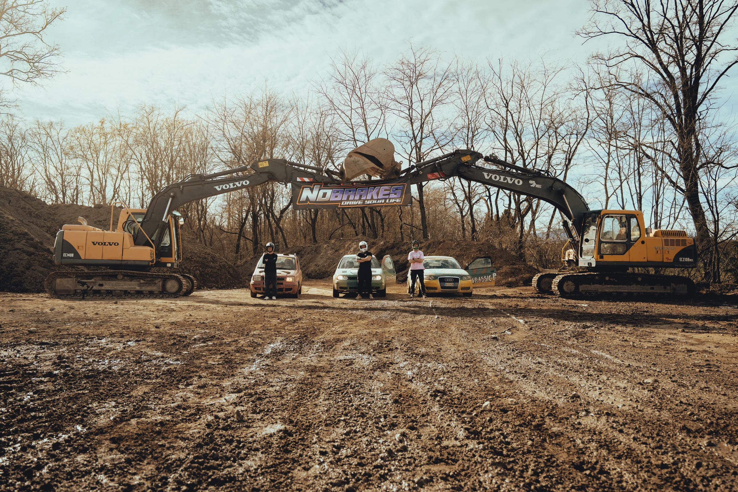 Automotive production with vehicles and machinery on outdoor terrain
