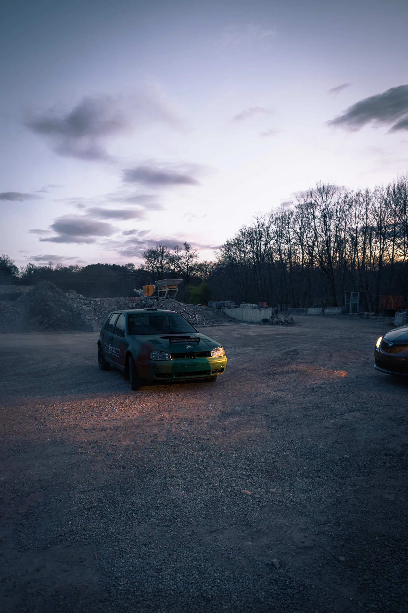 Rally car on a forest track at dusk