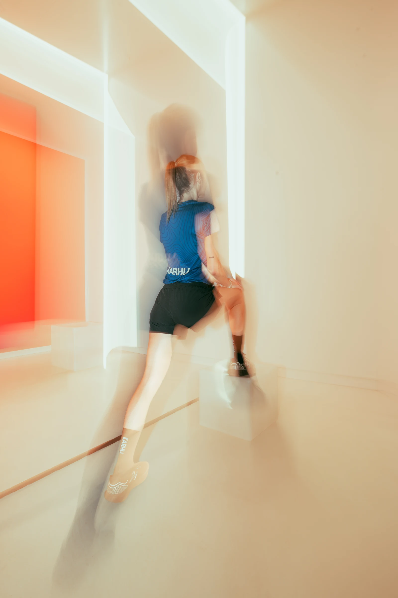 Female runner moving through a bright corridor