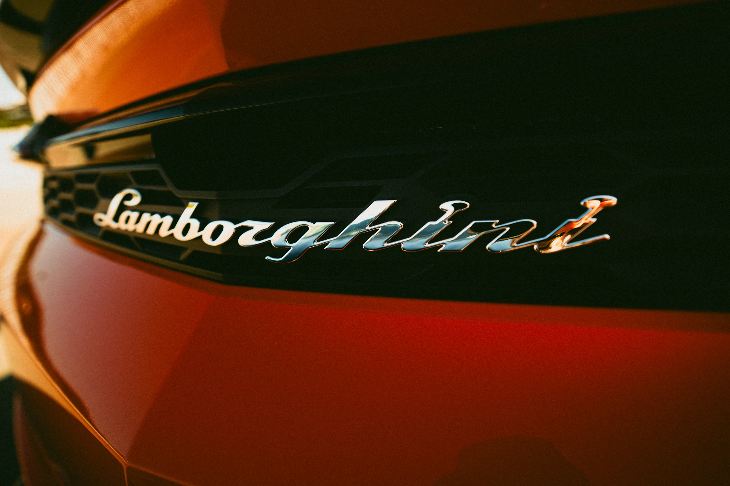 Close-up of the Lamborghini badge on orange bodywork