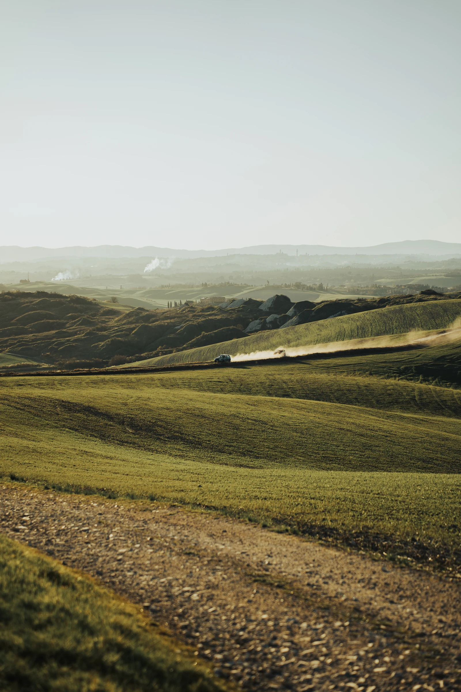Off-road vehicle crossing a vast rolling landscape