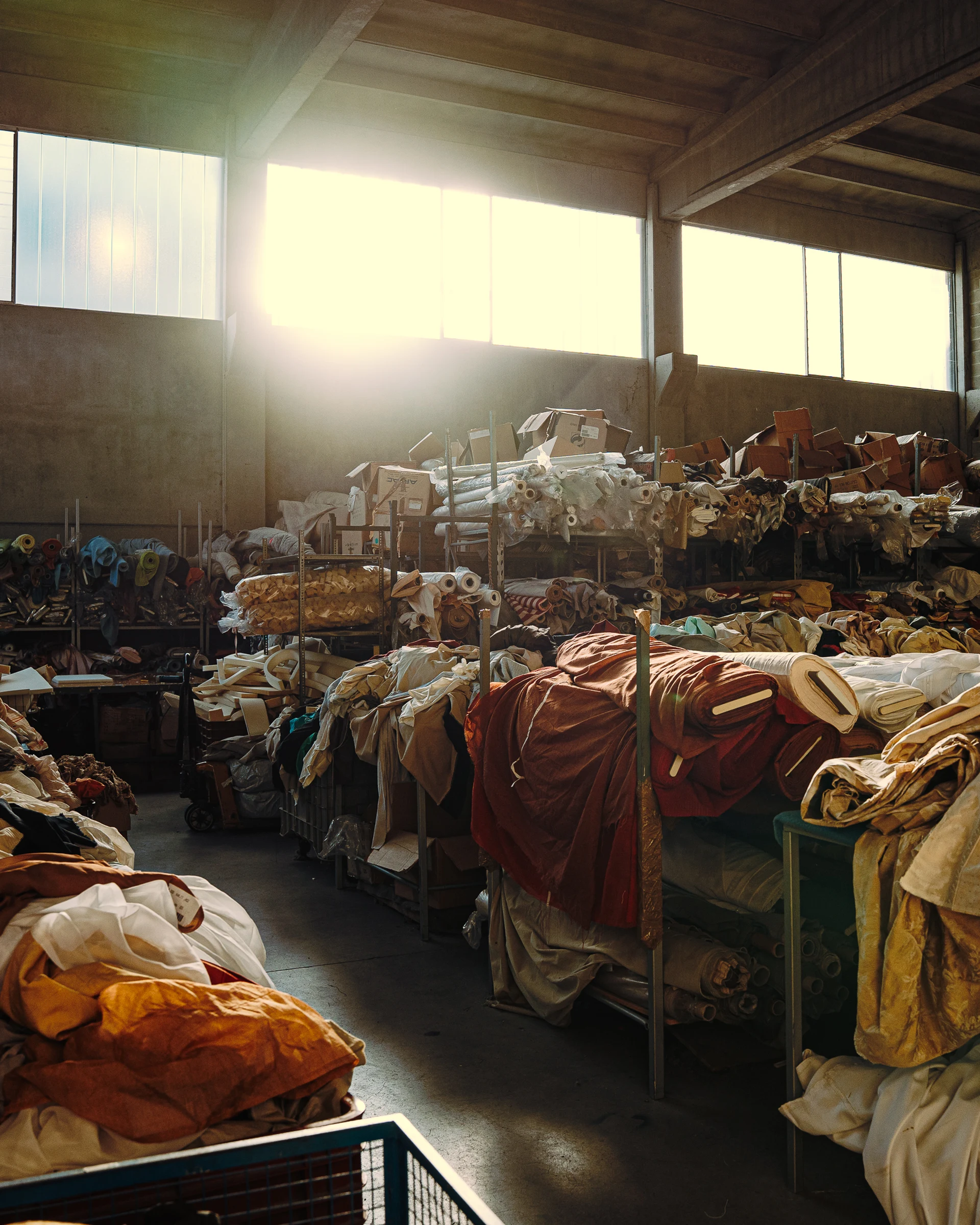 Sunlit textile stall inside a covered market