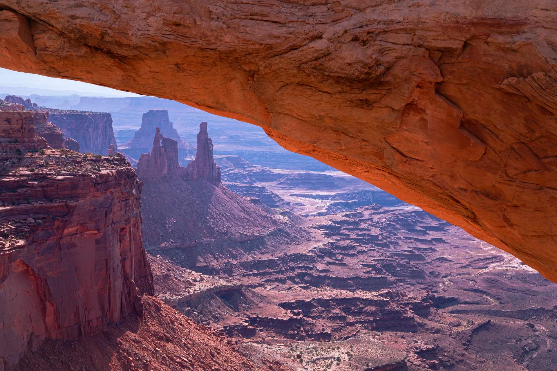 Desert canyon seen through Mesa Arch in Utah